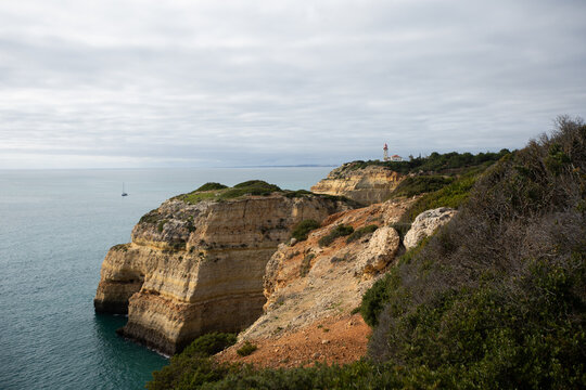 Panoramic, overhead view of the Algave coast featuring Farol de Alfanzina lighthouse