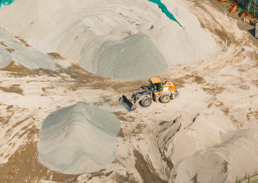 bulldozer on earthmoving at construction site, aerial view.