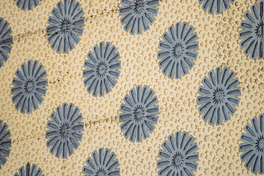 Floral textile with gray flower design on beige creates seamless repeating pattern