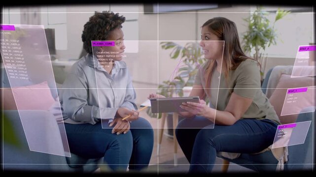 Business meeting, right woman tapping tablet bringing magenta UI panels, left woman noting pencil