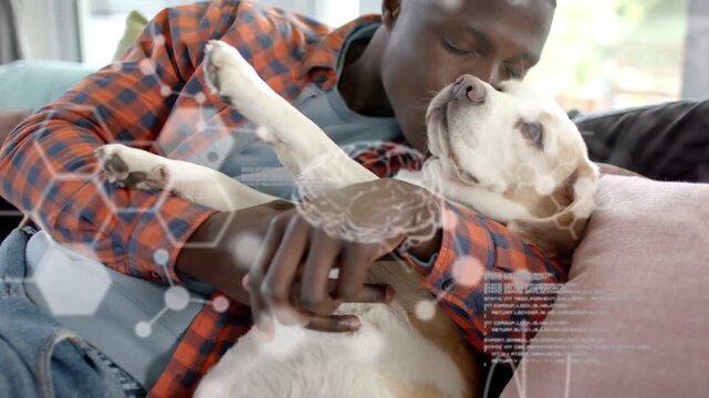 Man holding dog, leaning in and stroking belly while digital code overlaying, aiding pet health