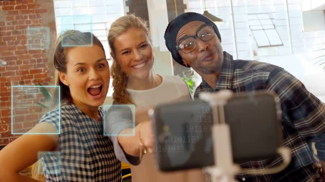 Center colleague holding phone mount, team posing for social, blue squares tracking faces