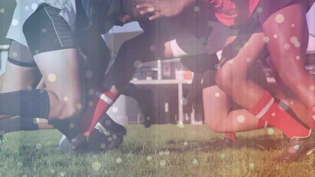 Male rugby players engaging scrum after inward push, hooking ball to win possession, bokeh on pack