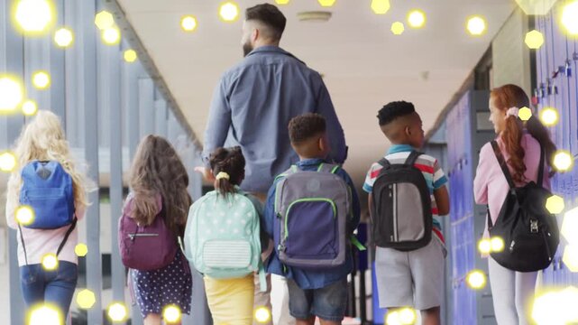 Adult male leading students walking school corridor, yellow bokeh overlay growing over blue lockers