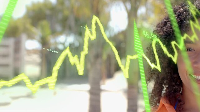 Woman standing smiling, finance updating animating yellow line, values and green bars passing