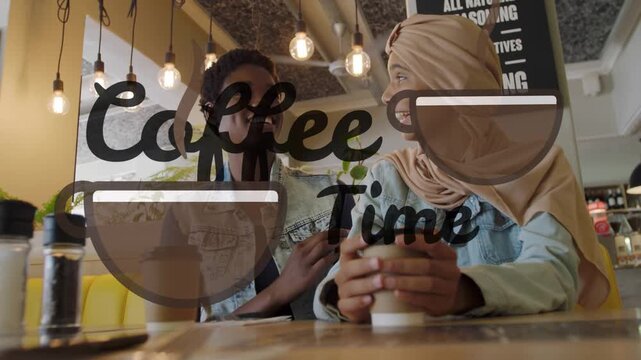 Two women leaning, left showing phone while chatting, right holding cup listening, cafe decal