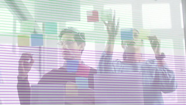 Right woman placing yellow note, left man arranging business on glass, scan-lines obscuring notes