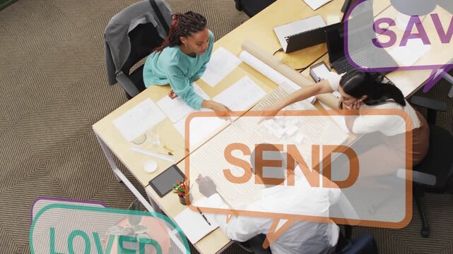 Three colleagues arranging cards for marketing plan around desk, causing animated social bubbles