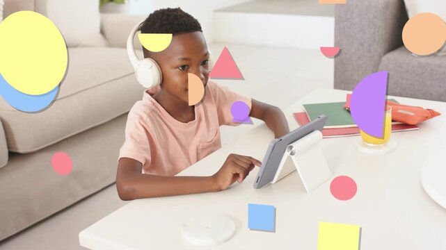 Child tapping tablet and initiating education app in living room, pastel shapes sweeping across