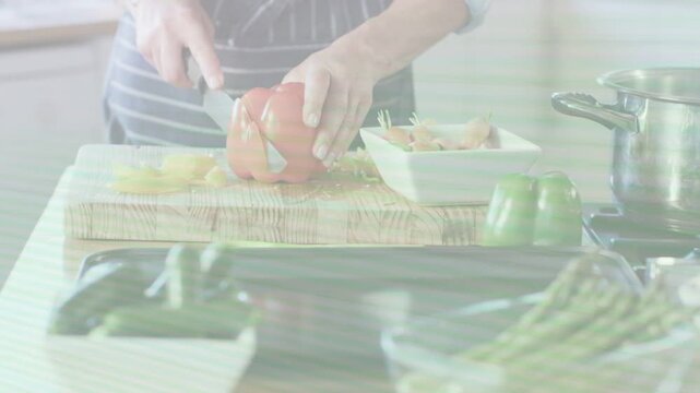 Home cook woman holding red pepper, making vertical incision with chef's knife, slicing for cooking