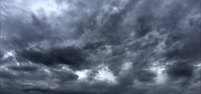 Dramatic dark storm clouds moving loop background. Moody dark clouds background loop