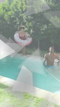 Vertical video: Woman with pink donut float adjusting and jumping in pool, man watching, for ads