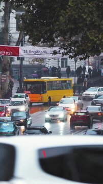 Tbilisi, Georgia. Traffic In Evening Street. Many Cars On Shota Rustaveli Ave Street. Police Cars With Active Rooftop Flashing Lights Provide Security