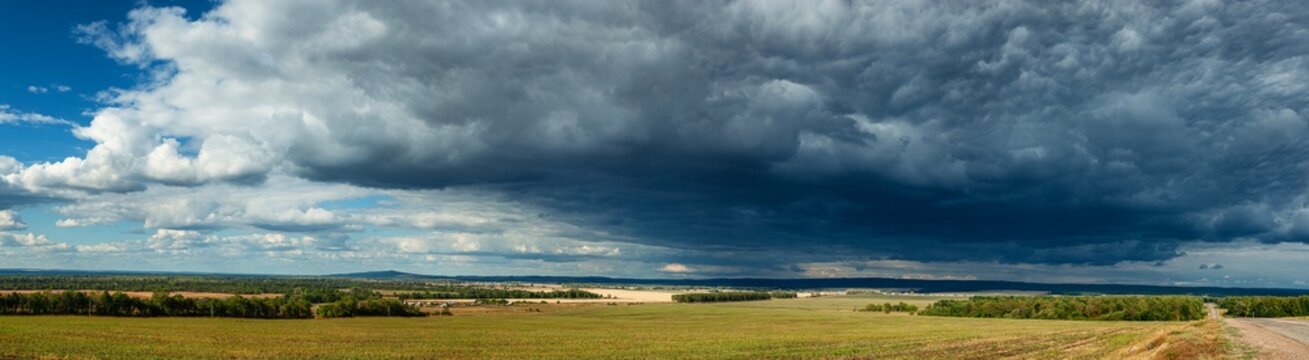 Southern Urals in summer: stormy sky over fields in the foothills of Bashkiria.