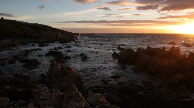 stormy sea meeting rocky coastline of DeKelders, South Africa