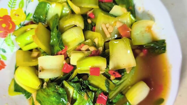 A serving of stir-fried Pak choi, a type of Chinese cabbage. Food cinematography concept for product or advertisement and culinary blog post.