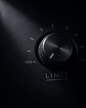 Silent control power not speaking dial knob limit minimal audio volume adjustment in dramatic low light creating moody industrial feeling