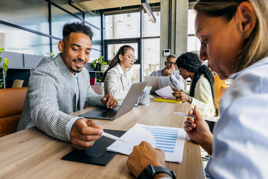 Collaborators Evaluate Documents And Strategies. Group Analyzes Data While Setting Future Objectives