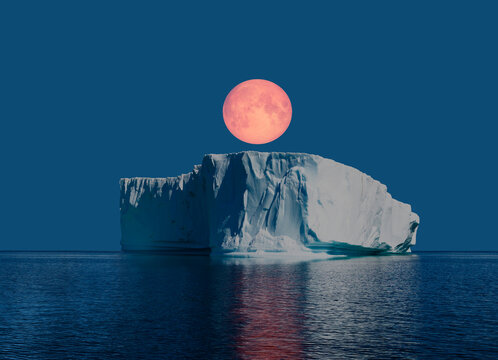 Melting icebergs by the coast of Greenland, on a beautiful summer day Full Moon in the background - Melting of a iceberg and pouring water into the sea  
