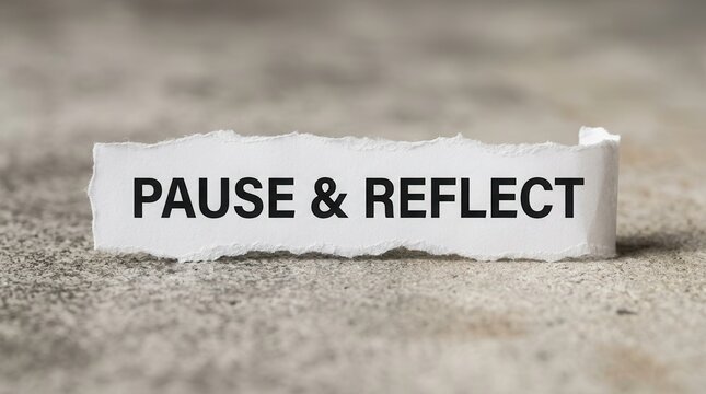 Torn paper with the words pause and reflect symbolizing personal mindfulness and contemplation.