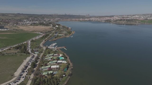 Cinematic High-Altitude Drone Flight Over Lake with Distant City View at Mogan Lake in Ankara, Turkey