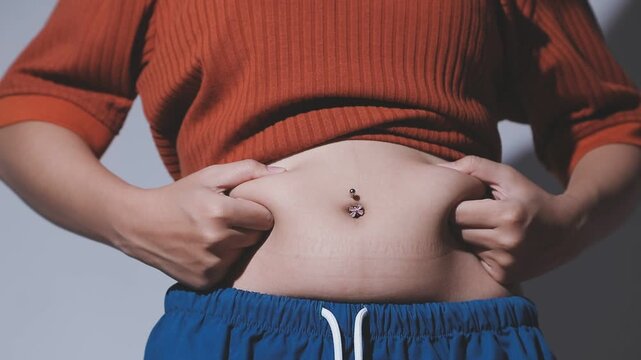 fat woman, fat belly, chubby, obese woman hand holding excessive belly fat with measure tape, woman diet lifestyle concept