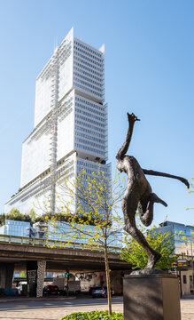 Clichy, France - April 7, 2026: "Tribunal de Paris" (Courthouse of Paris) building by architect Renzo Piano, achieved in 2017, with "L'Equilibre", a bronze statue by Andr&eacute; Hogommat in the foreground.