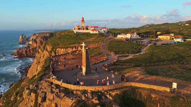 Cabo da Roca, Cape Roca, Cliffs and Atlantic Ocean at Sunset. Lighthouse and Cross. Portugal. Aerial View. Orbiting