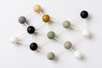 Obraz premium Top down view of a connected node network featuring various colored spheres and sticks on a white background, illustrating a geometric structure and design concept