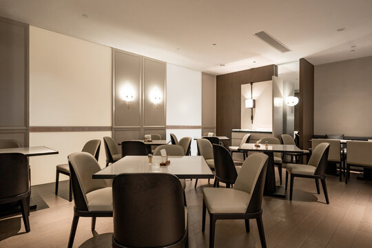 Modern minimalist restaurant interior with elegant table settings and ambient lighting