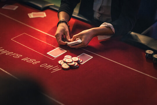 Close-up of poker player hands placing chips on casino table symbolizing calculated risk, strategy and high-stakes business decision making.