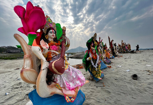 Idols of Hindu Goddess Saraswati are seen strewn in the bank of Brahmaputra river