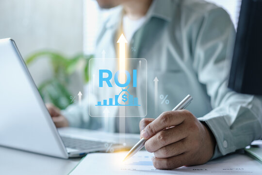 Business professional analyzing ROI optimization performance using laptop and financial report with growth arrow overlay, data-driven decision making concept for finance, marketing, strategy planning