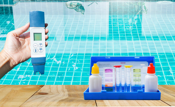 Digital water tester in girl hand over blurred swimming pool water background, quality water testing tool, pool maintenance and service business concept