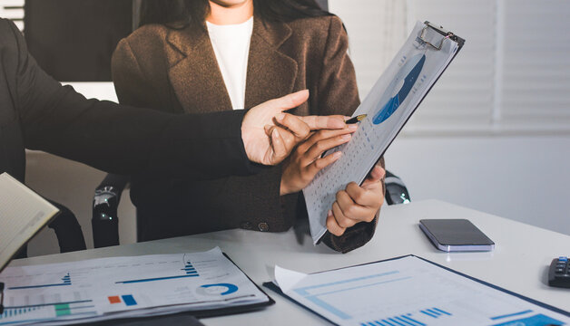 Accountants processing financial documents and taxes, managing corporate finance in a modern office. Audit and taxes in business