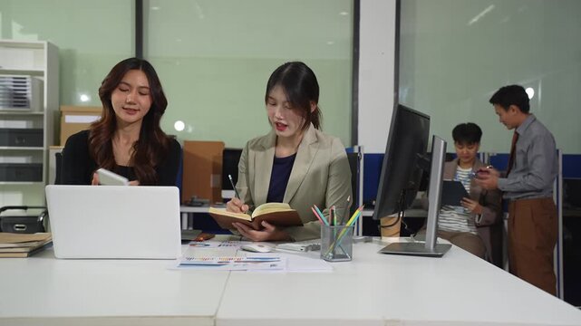 Co working team meeting concept: Business woman working and studying together with tablet document graph paper in office, discuss finance and marketing solution reporting file in working place.