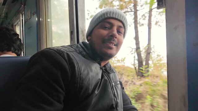 man smiling inside vintage kalka shimla toy train himachal pradesh india