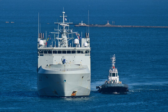Royal Canadian Navy offshore patrol vessel HMCS Max Bernays (AOPV 432) sailing with escort tugboat.