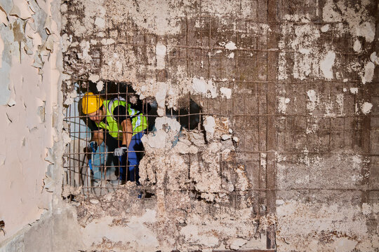 Cracked plaster surfaces reveal bold graffiti artwork in decay
