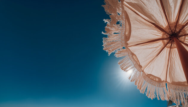 An upward-facing shot capturing the intricate texture of multiple thatched straw umbrellas on a beach, framed against a bright blue sky. This image perfectly conveys themes of summer vacation