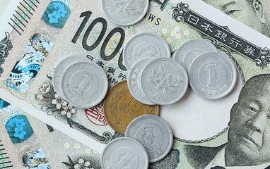 Japanese yen money bills and coins on table. Japan cash of JPY currency close up © Larysa