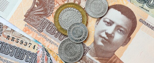 Cambodian riel money bills and coins on table. Cambodia cash of KHR currency © Larysa