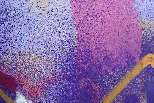 Beautiful brick wall colorful street art graffiti background. Abstract creative spray drawing fashion colors painting on the walls of the city. Urban Culture, aerosol texture