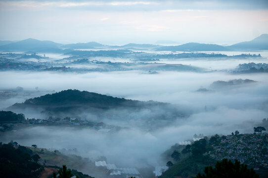The view of Da Lat from Du Sinh Cemetery towards the city center. Da Lat on a morning shrouded in mist and early sunlight, a magical morning light. Beautiful Vietnamese scenery.