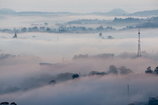 The view of Da Lat from Du Sinh Cemetery towards the city center. Da Lat on a morning shrouded in mist and early sunlight, a magical morning light. Beautiful Vietnamese scenery.