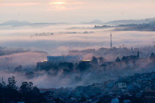 The view of Da Lat from Du Sinh Cemetery towards the city center. Da Lat on a morning shrouded in mist and early sunlight, a magical morning light. Beautiful Vietnamese scenery.