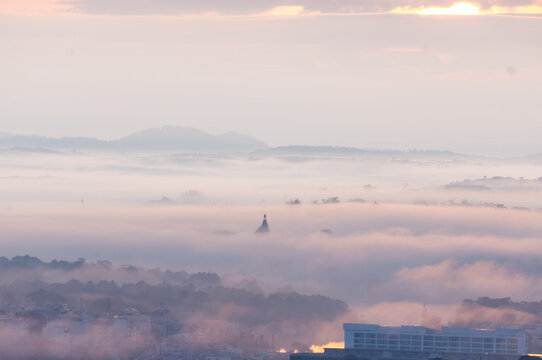 The view of Da Lat from Du Sinh Cemetery towards the city center. Da Lat on a morning shrouded in mist and early sunlight, a magical morning light. Beautiful Vietnamese scenery.