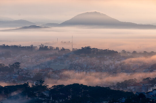 The view of Da Lat from Du Sinh Cemetery towards the city center. Da Lat on a morning shrouded in mist and early sunlight, a magical morning light. Beautiful Vietnamese scenery.