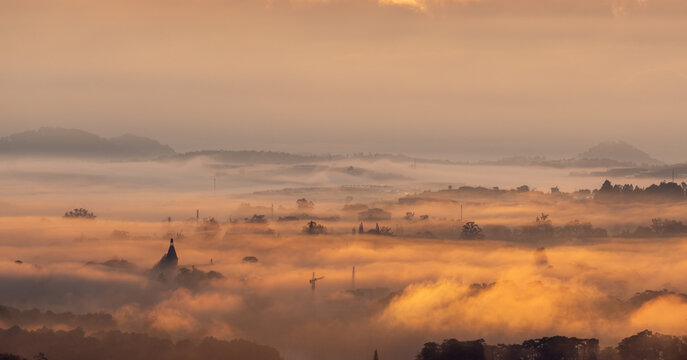 The view of Da Lat from Du Sinh Cemetery towards the city center. Da Lat on a morning shrouded in mist and early sunlight, a magical morning light. Beautiful Vietnamese scenery.