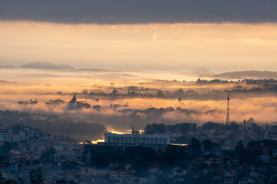 The view of Da Lat from Du Sinh Cemetery towards the city center. Da Lat on a morning shrouded in mist and early sunlight, a magical morning light. Beautiful Vietnamese scenery.